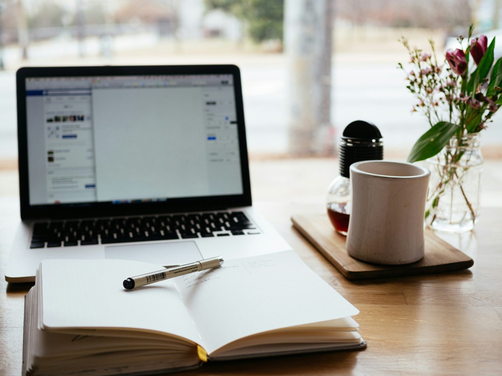 An image of a computer with a notebook.